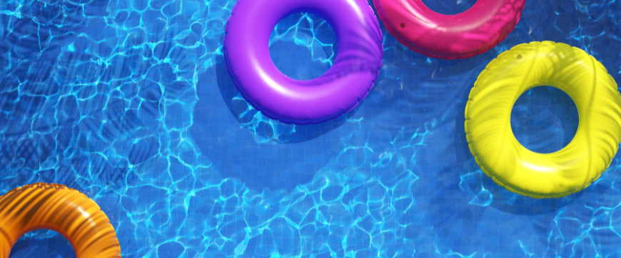 Pool water with colourful floating inner tubes 